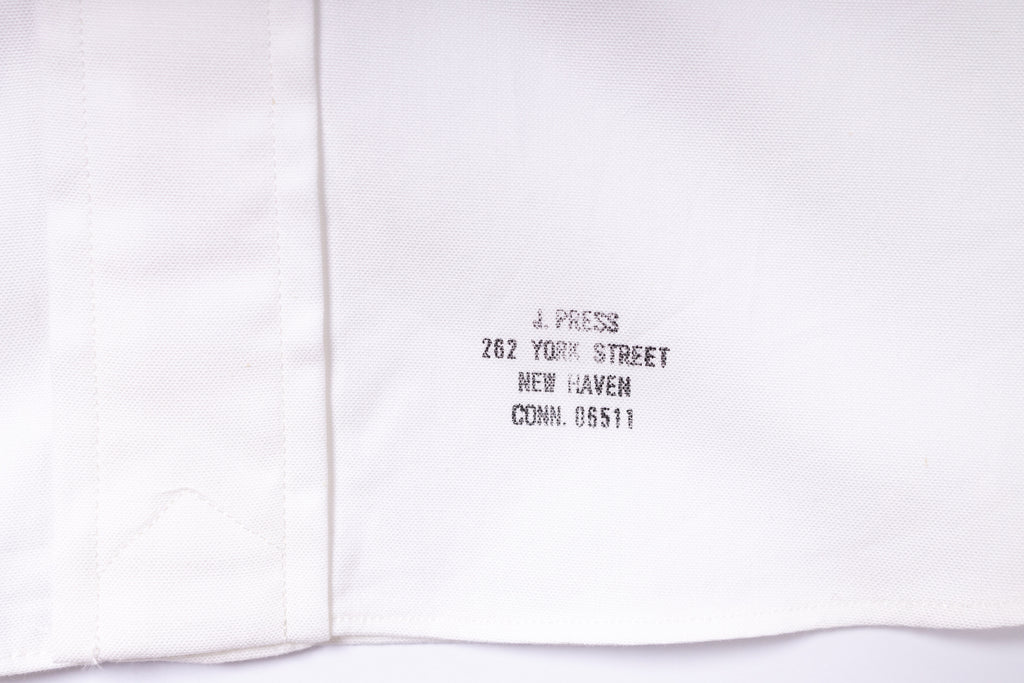 White shirt with black text on a white background