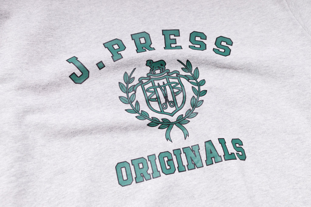 Close-up of a white shirt with 'J. Press Originals' text and logo.