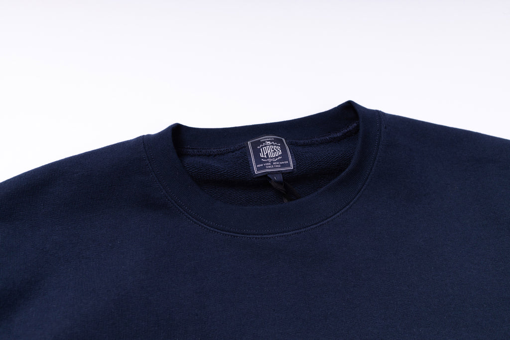 Navy blue sweatshirt with a brand label on a white background