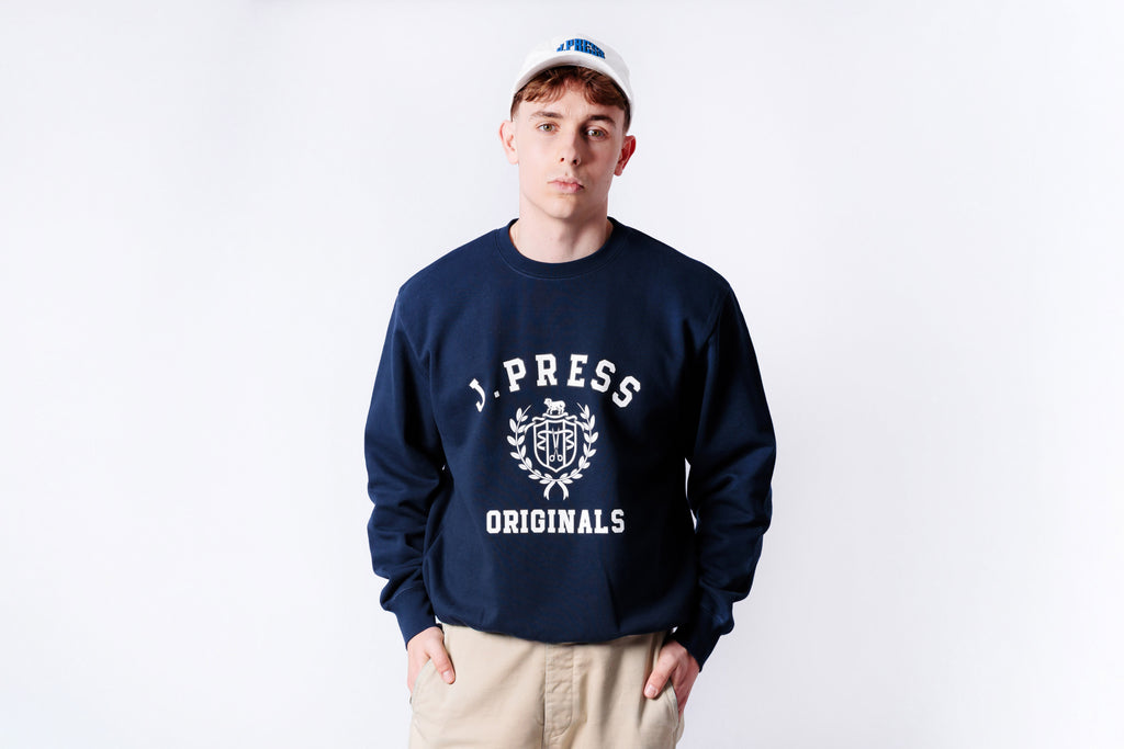 Person wearing a navy blue sweatshirt with 'J.PRESS ORIGINALS' logo on a white background
