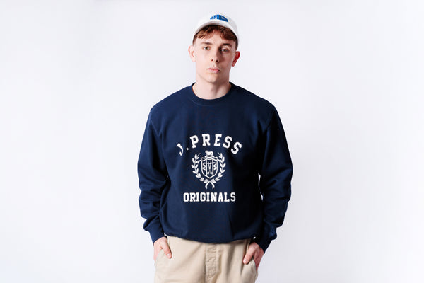 Person wearing a navy blue sweatshirt with 'J.PRESS ORIGINALS' logo on a white background