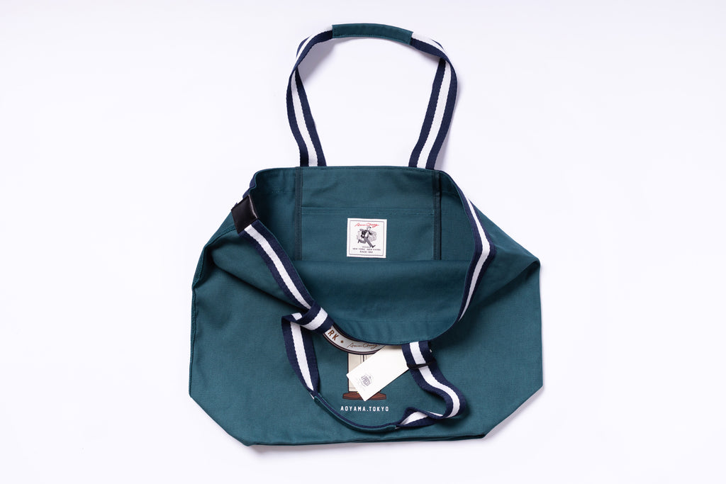 Green tote bag with white accents on a white background