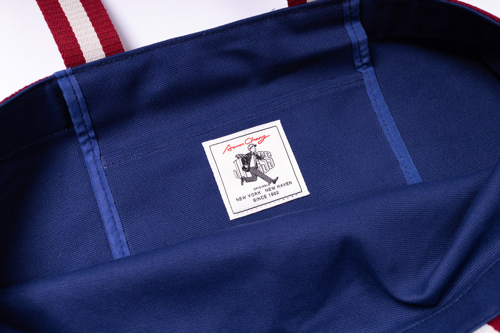 Close-up of a blue garment with a brand label featuring a logo and text.