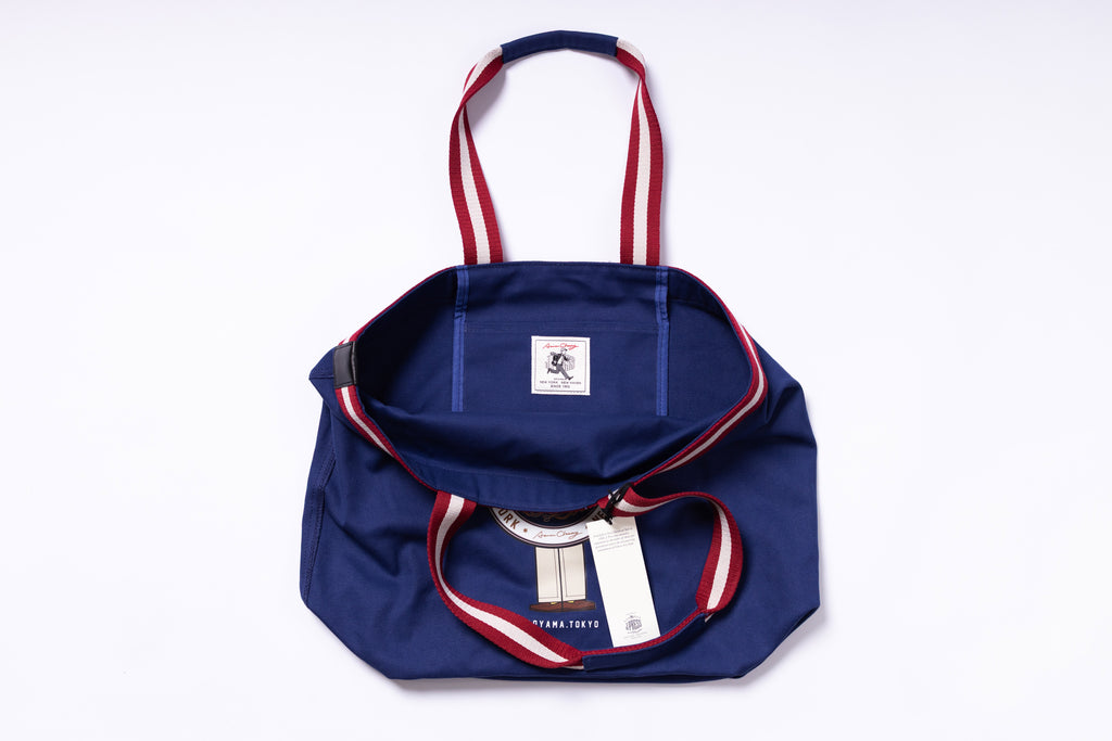 Navy blue bag with red and white accents on a white background