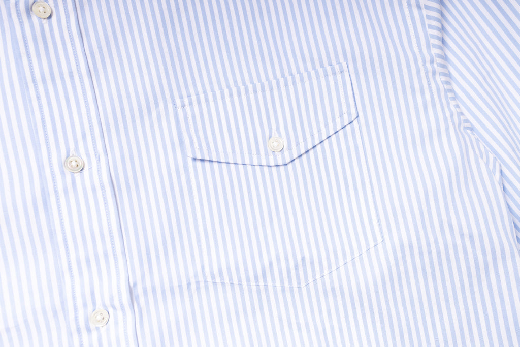 Close-up of a blue and white striped shirt with a pocket detail.