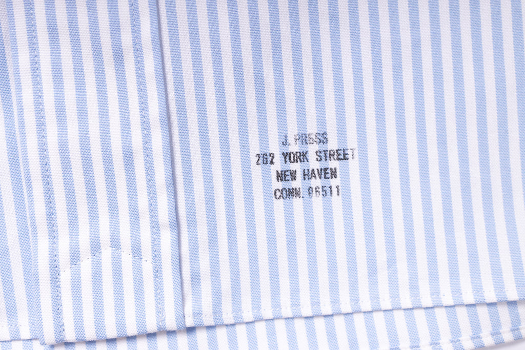 Close-up of a blue and white striped fabric with a brand label.