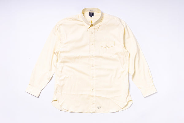 Light yellow button-up shirt on a white background