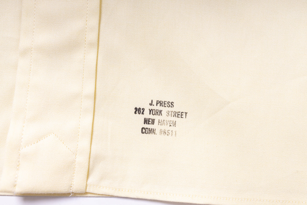 Text on a beige fabric background with 'J. Press' branding.