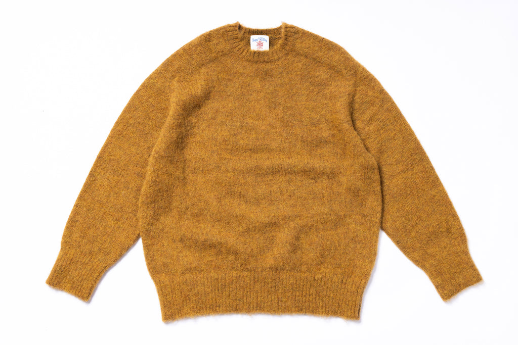 Mustard yellow sweater on a white background