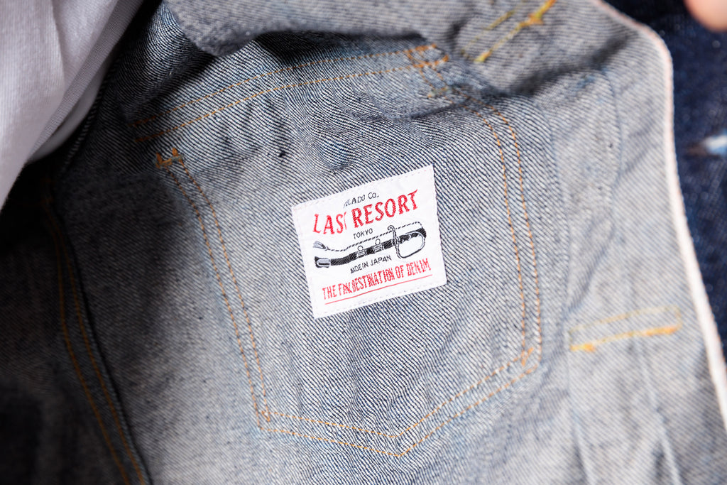 Close-up of a denim jacket with a label on the pocket