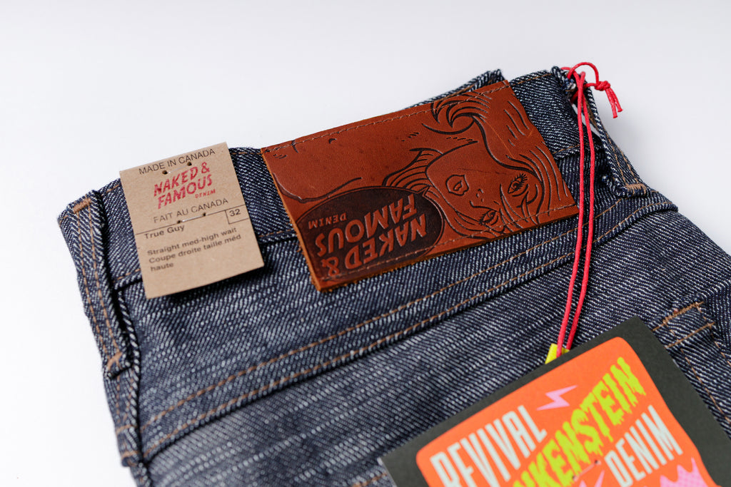 Folded jeans with brand labels on a white background