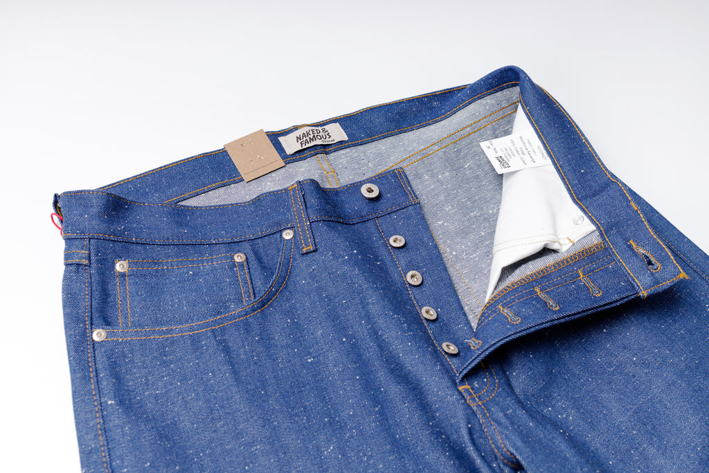 Blue jeans with a visible brand label on a white background