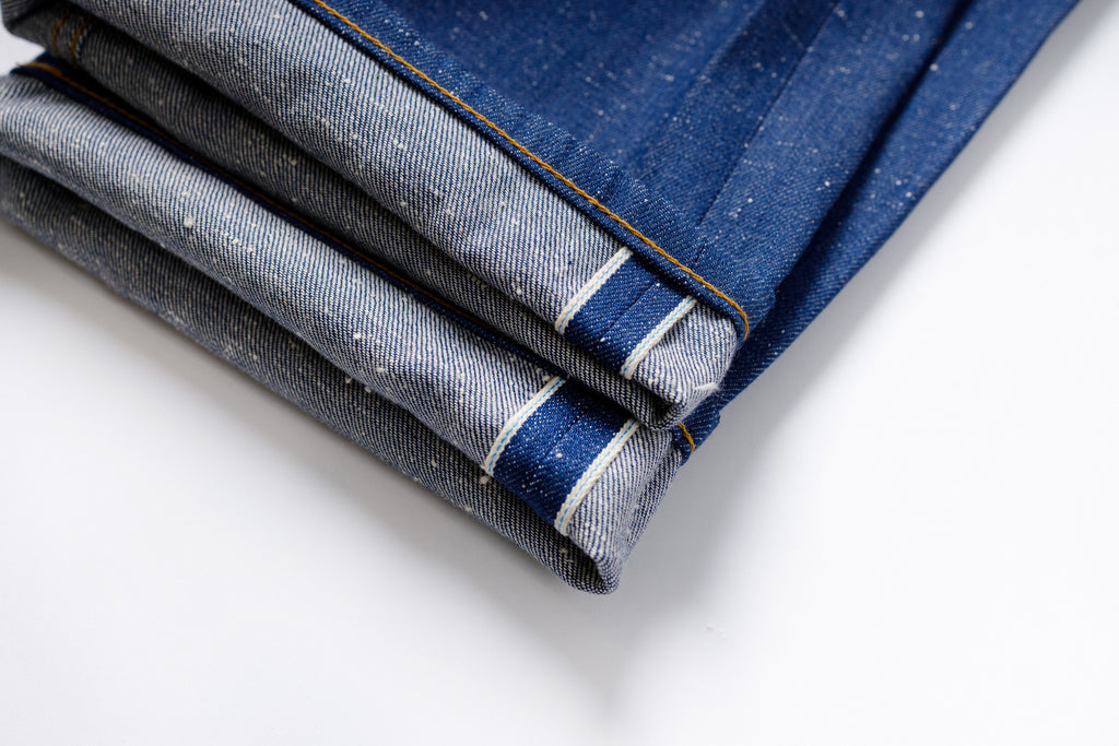 Folded denim fabric on a white background