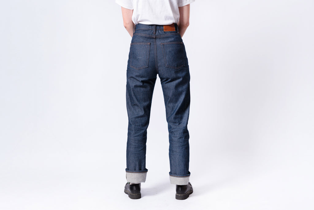 Person wearing blue jeans on a white background