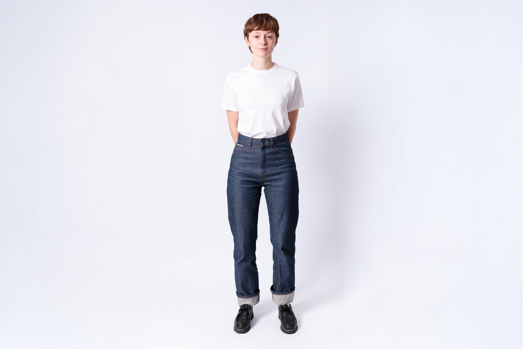 Person wearing a white shirt and blue jeans on a white background