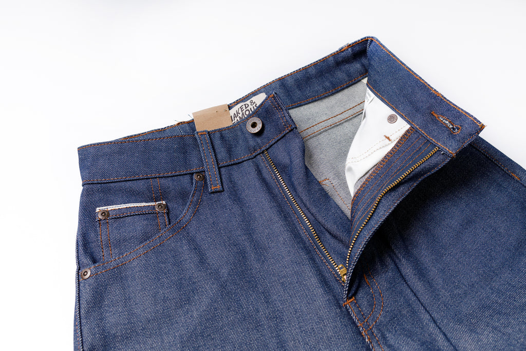 Blue jeans with a brand label on a white background