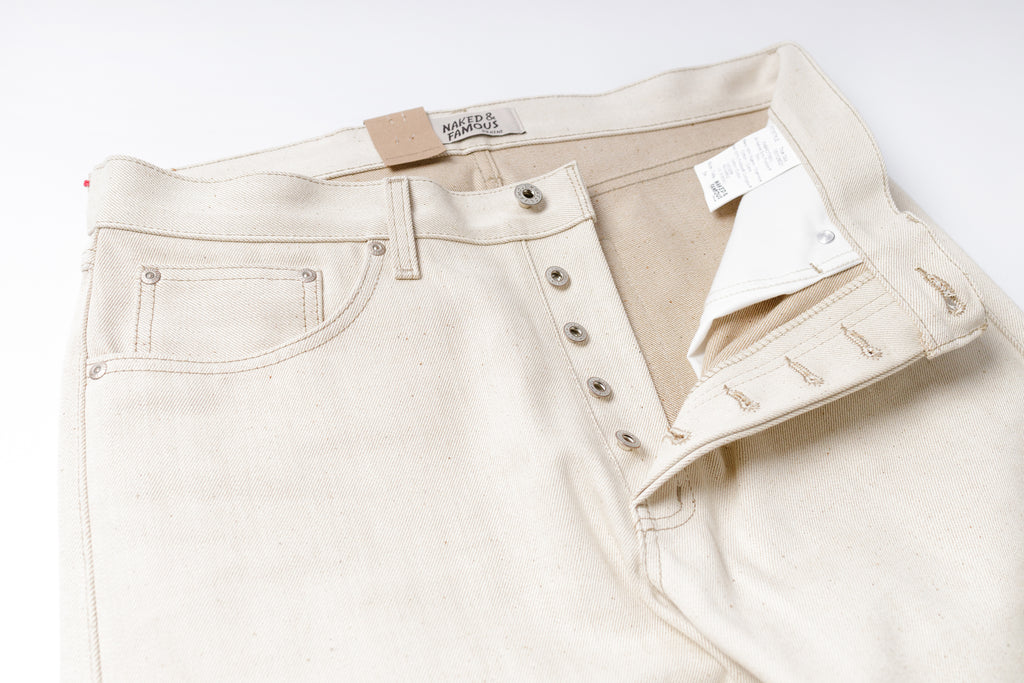 Ecru Jeans with a brand label on a white background