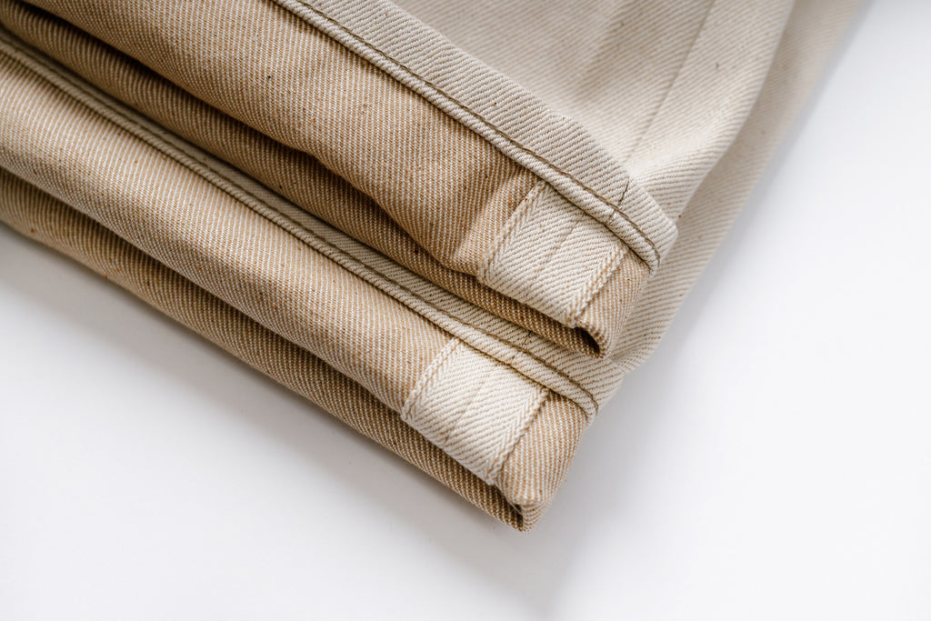 Folded beige fabric on a white background