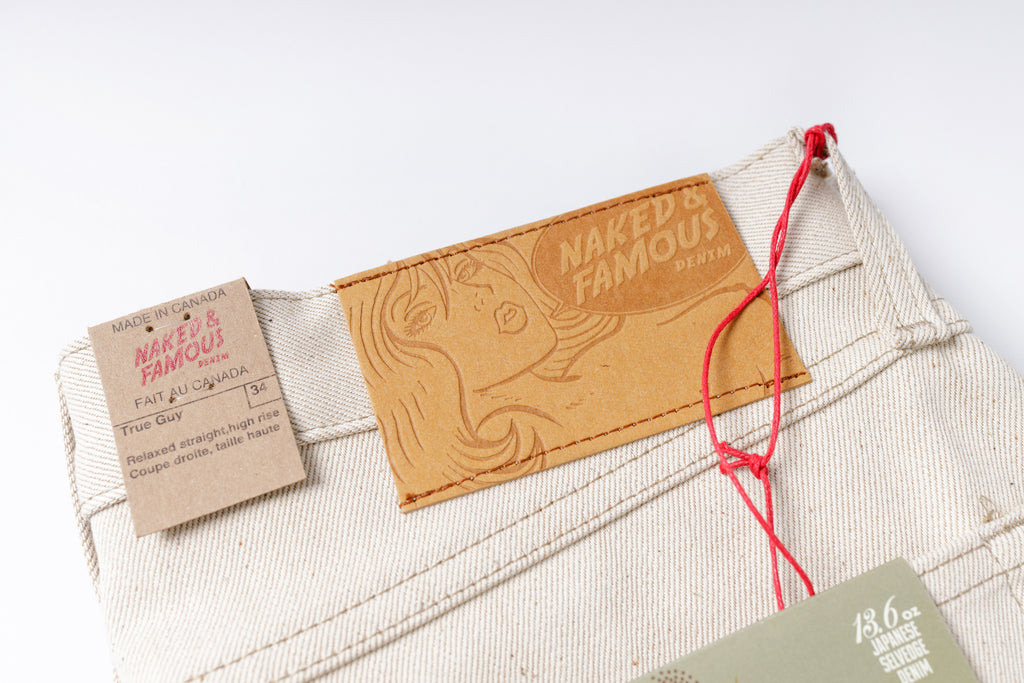 Close-up of a label on a product with 'Naked & Famous' branding.