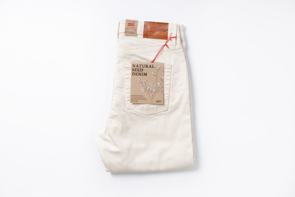 White jeans with a brown label on a white background