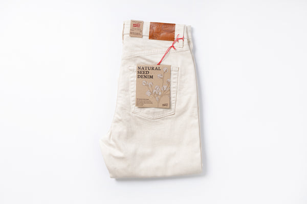 White jeans with a brown label on a white background