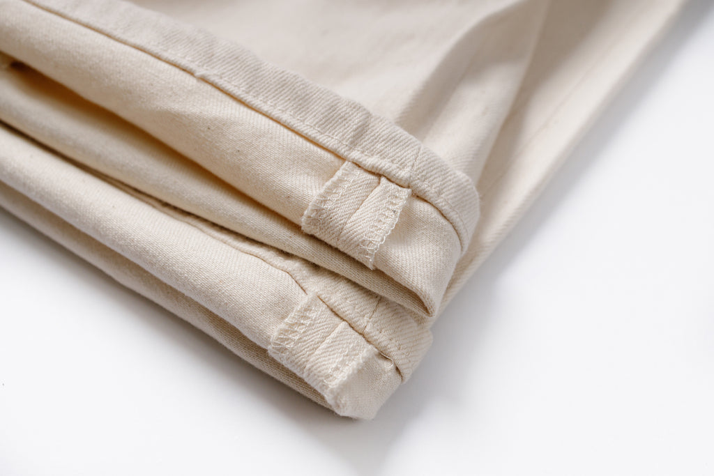 Folded beige fabric on a white background