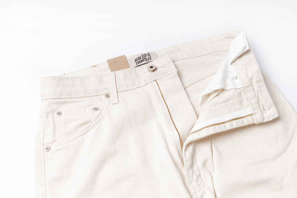 White jeans with a brand label on a white background