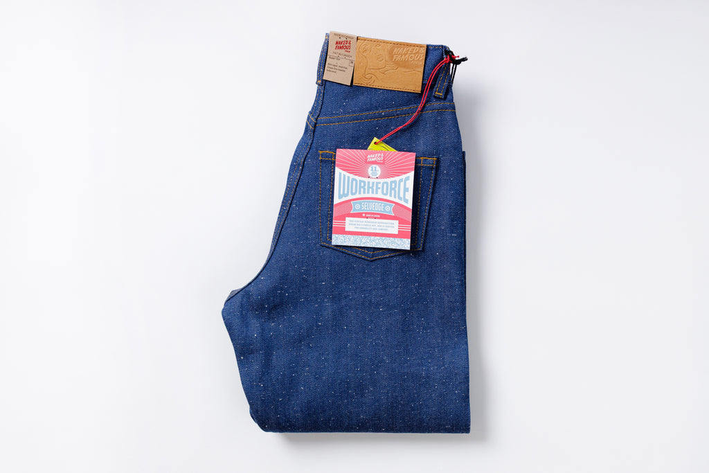 Folded blue jeans with a Levi's tag on a white background