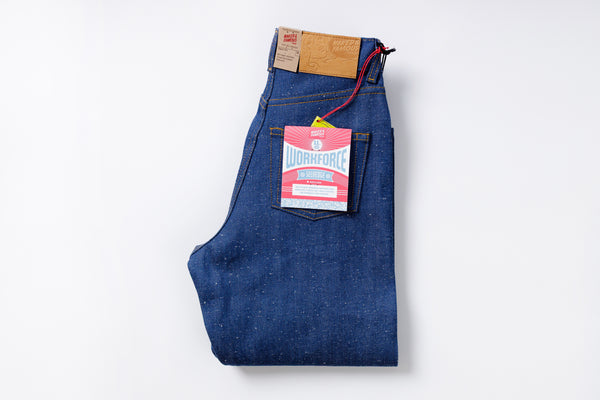 Folded blue jeans with a Levi's tag on a white background