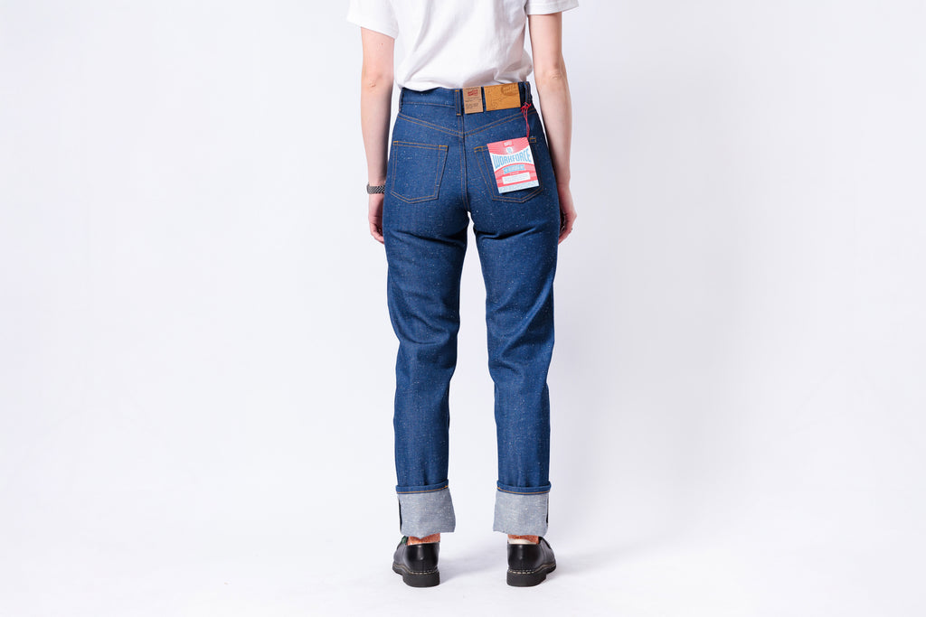 Person wearing blue jeans with a white background