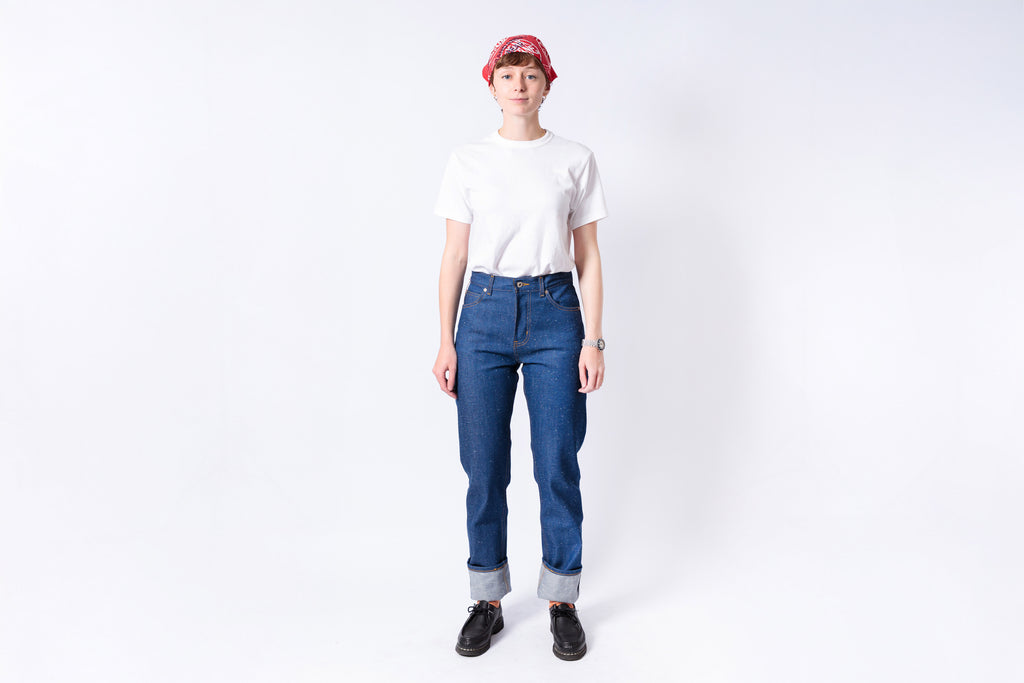 Person wearing a white t-shirt, blue jeans, and a red cap on a white background