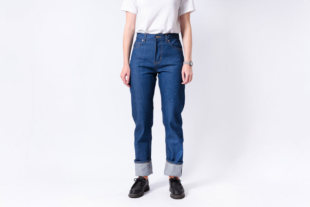 Person wearing blue jeans and a white shirt on a white background