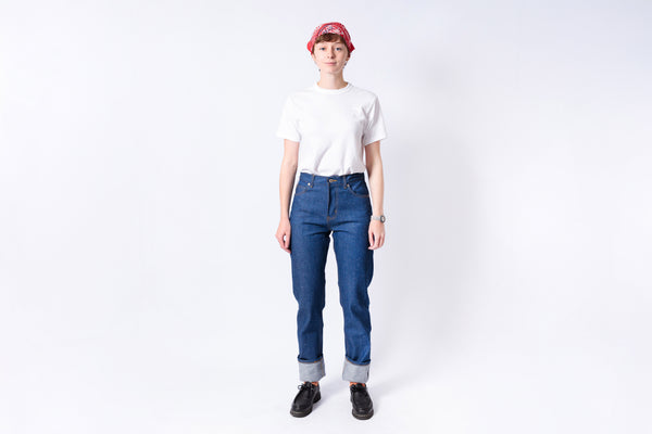 Person wearing a white t-shirt, blue jeans, and a red cap on a white background