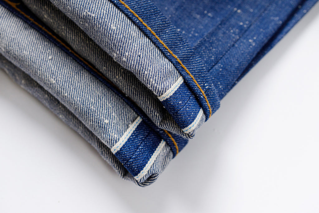 Close-up of folded denim fabric on a white background