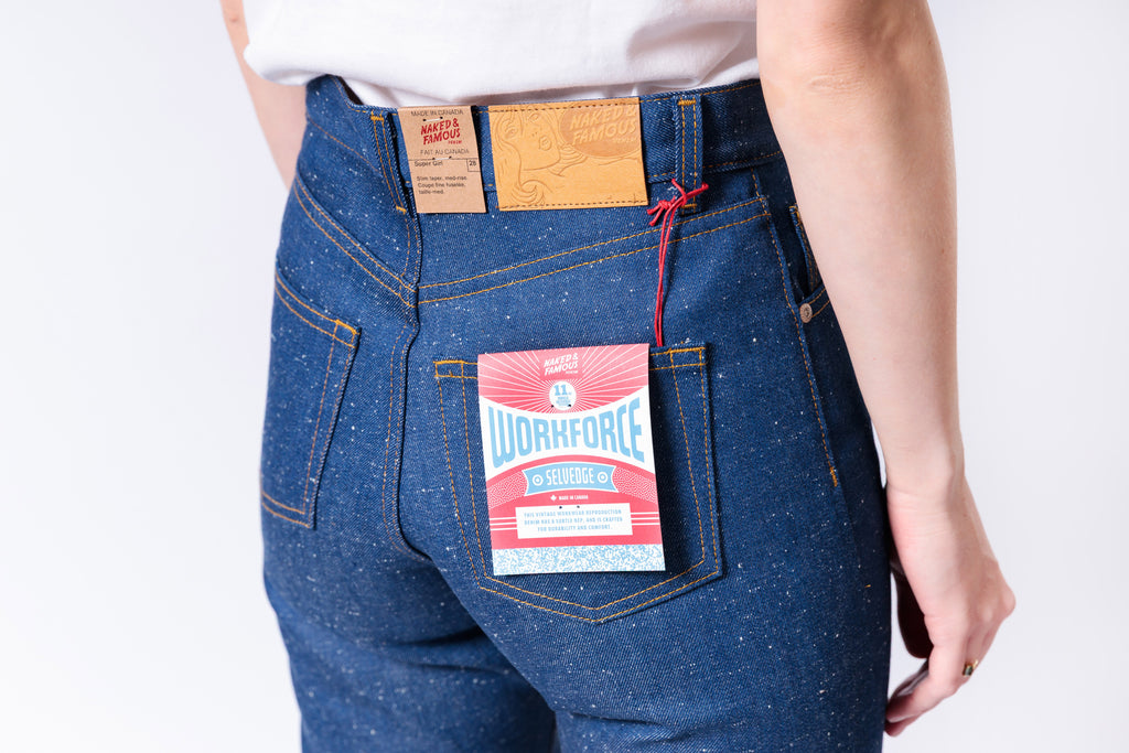 Blue jeans with a visible brand label on a white background