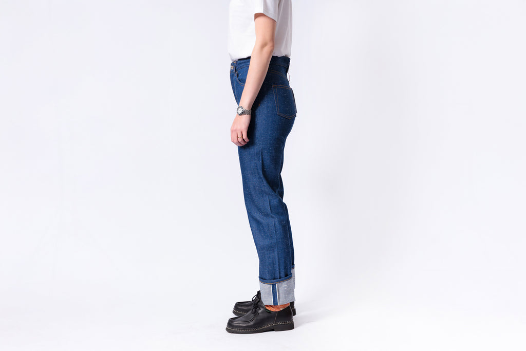 Person wearing blue jeans with a white background