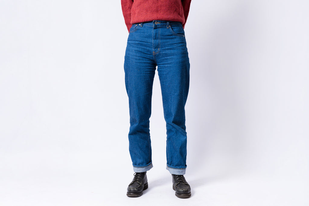 Person wearing blue jeans on a white background