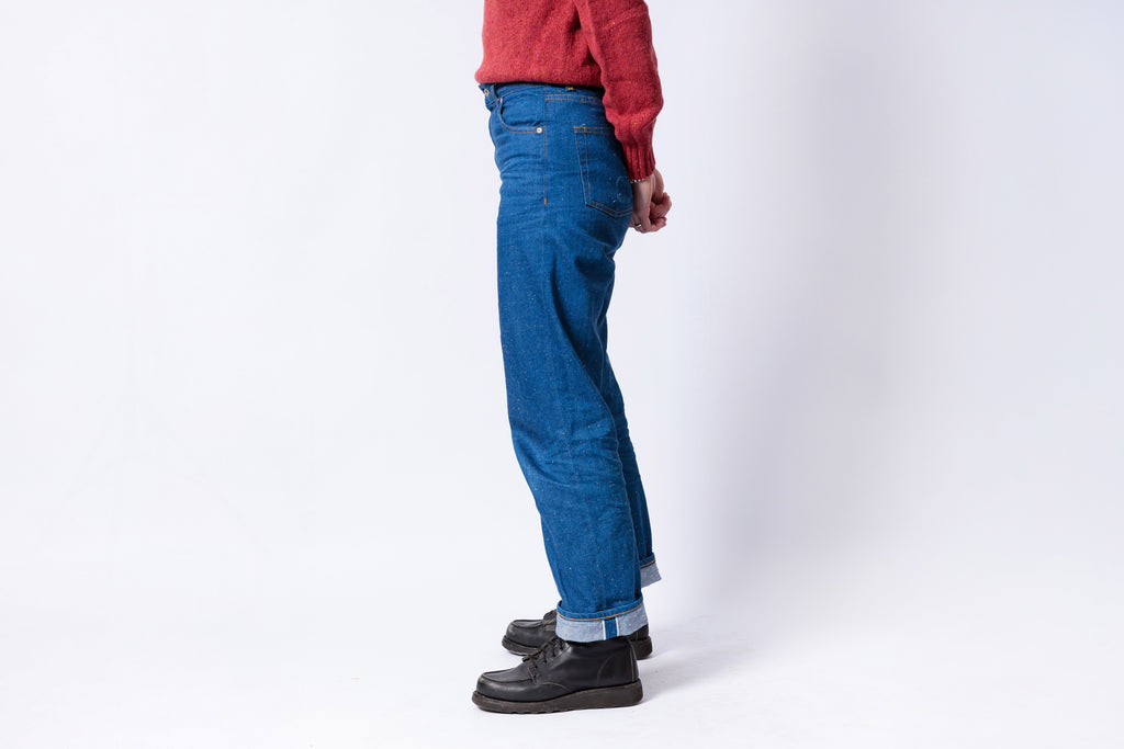 Person wearing blue jeans and a red shirt on a white background