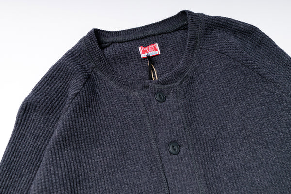 Gray textured sweater with buttons on a white background