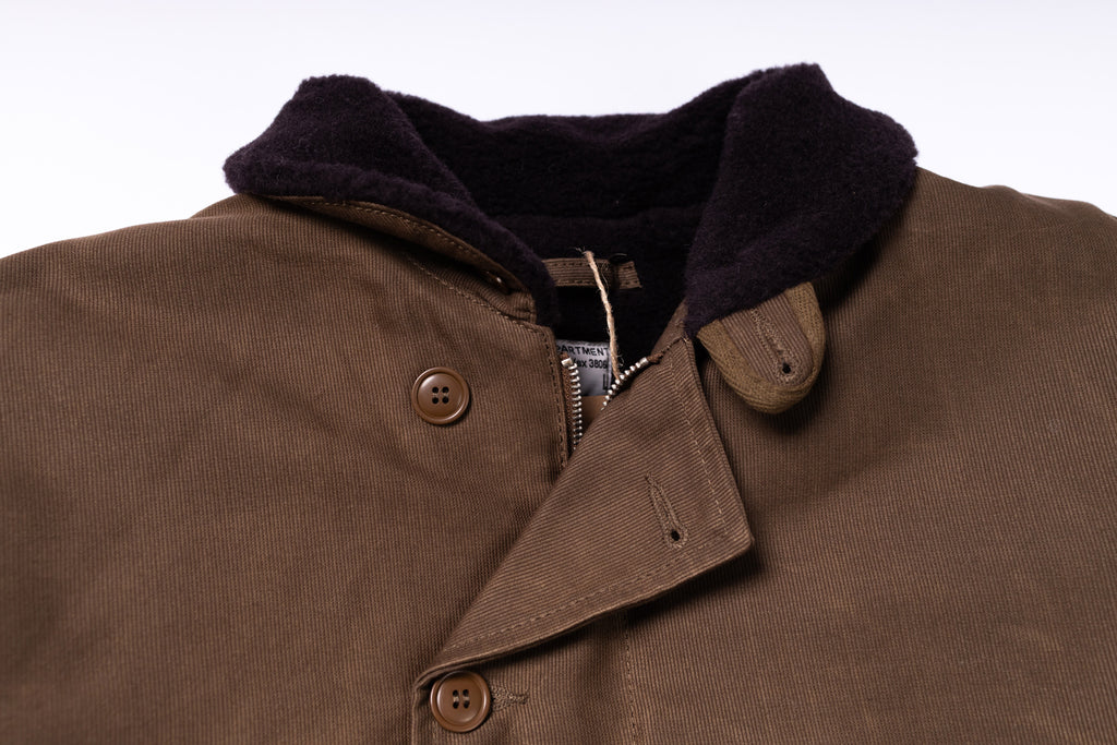 Close-up of a brown jacket with a dark collar on a white background