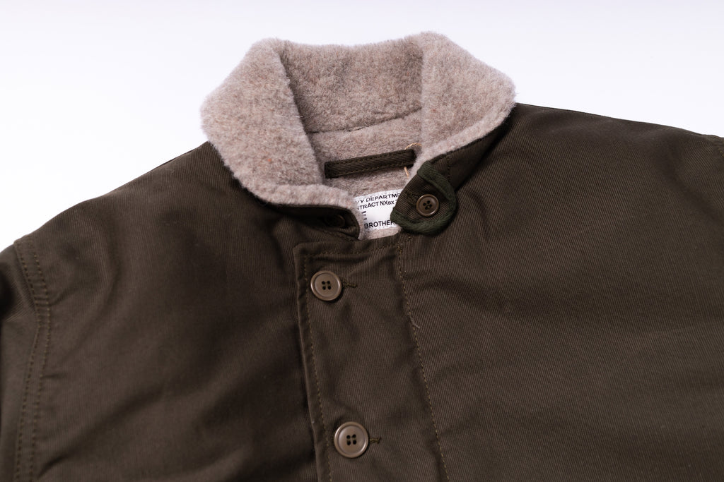 Brown jacket with gray fleece collar on a white background