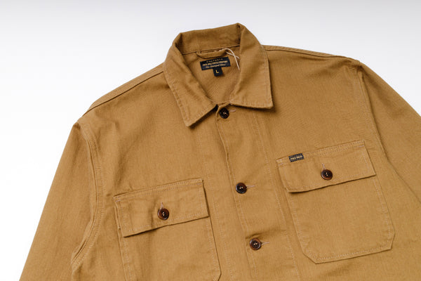 Brown jacket with two front pockets and button details on a white background