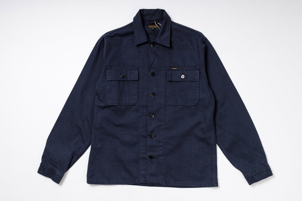 Navy blue shirt with button details on a white background