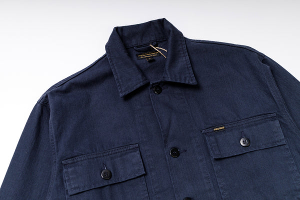 Navy blue jacket with button details on a white background