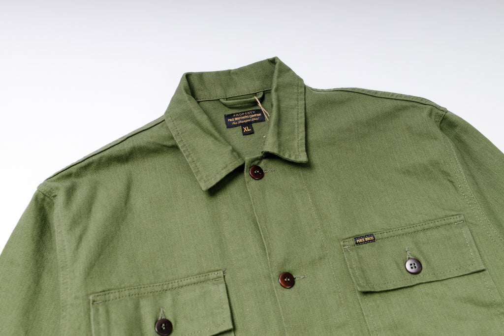 Green shirt with collar and button details on a white background