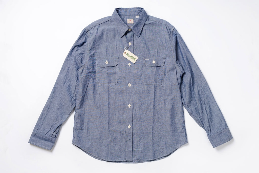 Blue denim shirt with a tag on a white background