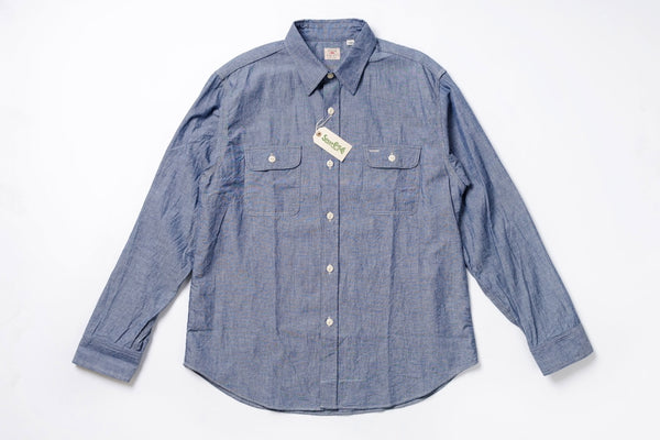 Blue denim shirt with a tag on a white background