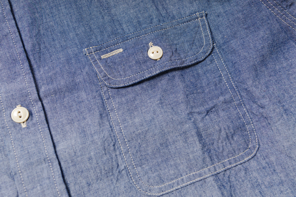 Close-up of a blue denim shirt with button details