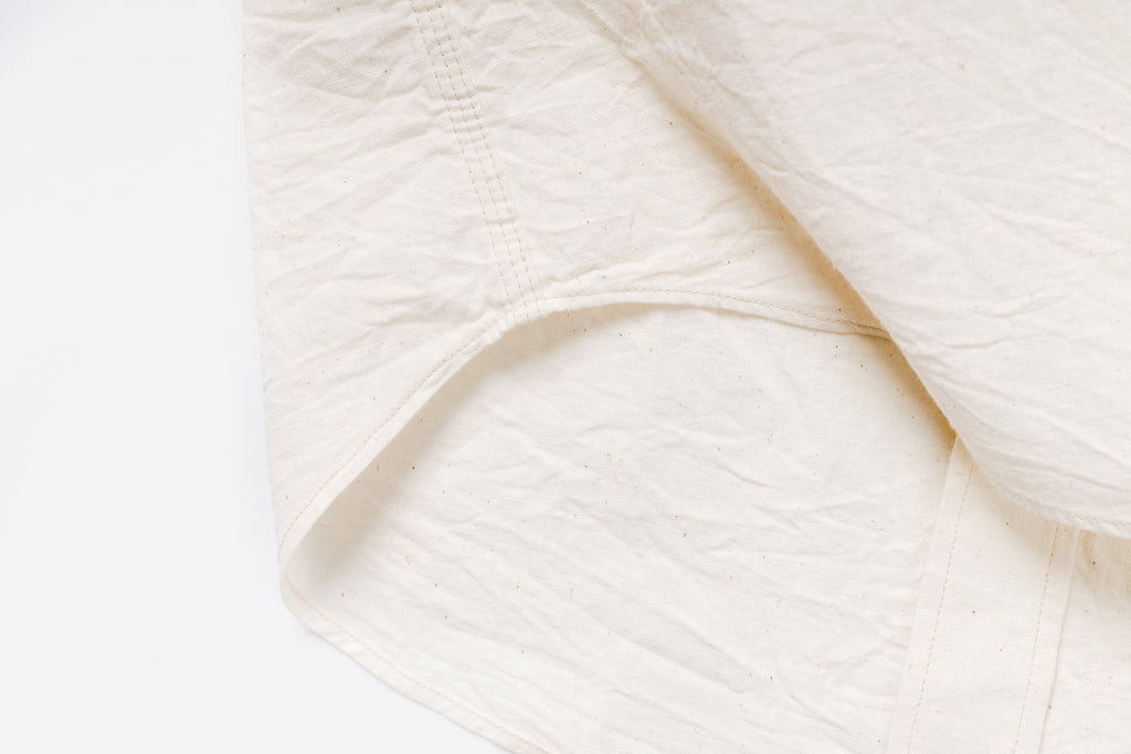 Close-up of white fabric with a soft texture on a light background