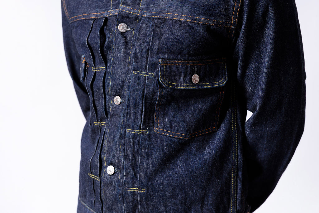Close-up of a blue denim jacket with buttons on a white background